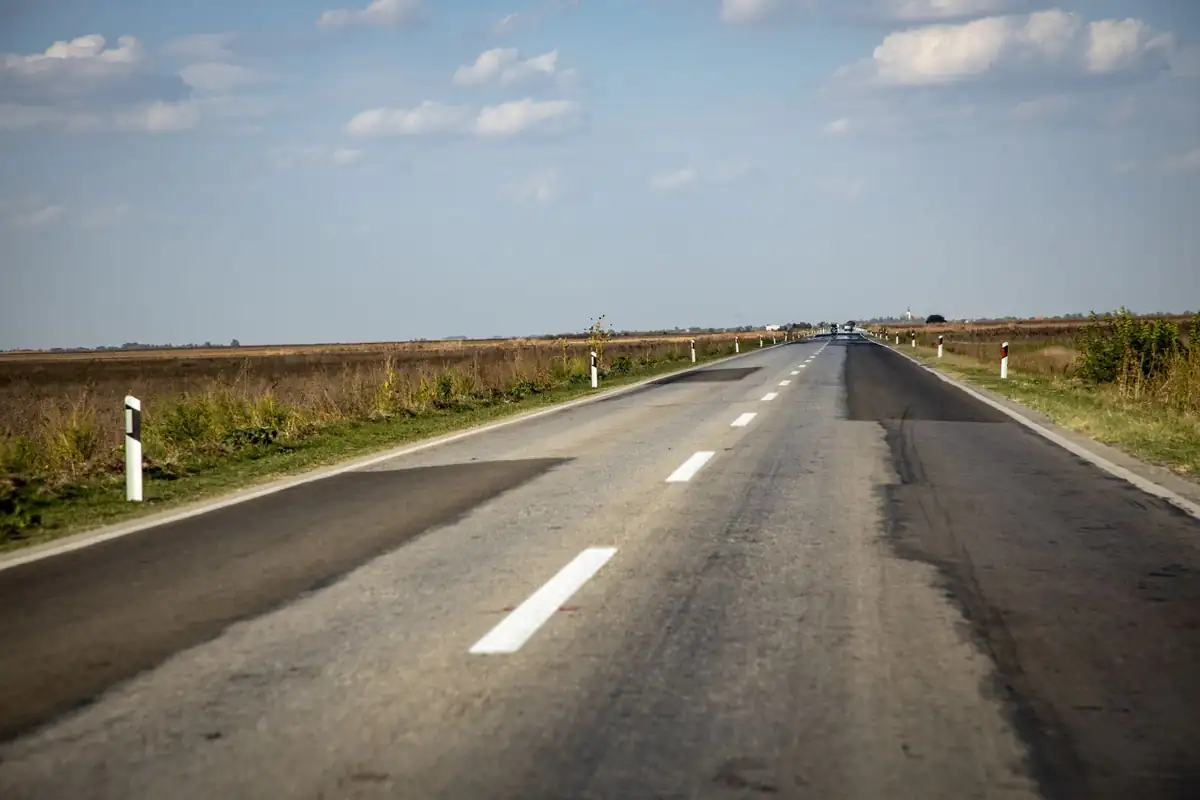 Fresh asphalt road with bold yellow center lines